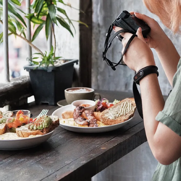 person taking a picture of their food